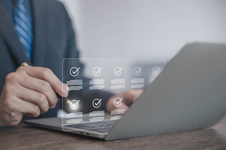 Online document verification concept with businessman using laptop, pointing at digital checklist interface for approval, secure workflow, efficient task management in modern business. document auditの写真素材