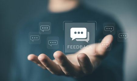 Feedback concept. chat bubble icon floating above hand, symbolizing customer opinions, review sharing, communication, evaluation, user experience improvement, and business response. customer feedbackの写真素材