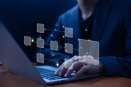 Businessman using a laptop. a flowchart hologram, symbolizing workflow automation, process management, digital transformation, data organization, system integration, and business efficiency.の写真素材