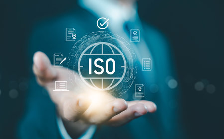 ISO certification concept. businessman holding digital globe and compliance icons, symbolizing international standards, quality assurance, auditing, and global business certification process.の写真素材