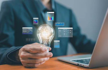 Businessman holding light bulb with AI technology icons and analytics dashboard, symbolizing artificial intelligence, innovation, data analysis, and future business strategy. smart data AIの写真素材