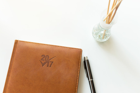 Notebook for new year and pen on white tableの写真素材