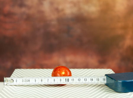 Math in Kitchen  - Tomato and ruler on grey groundの写真素材