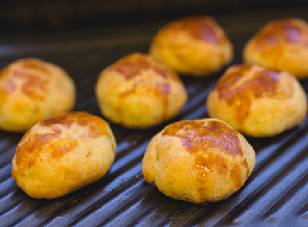 Homemade traditional savory pastries on baking trayの写真素材