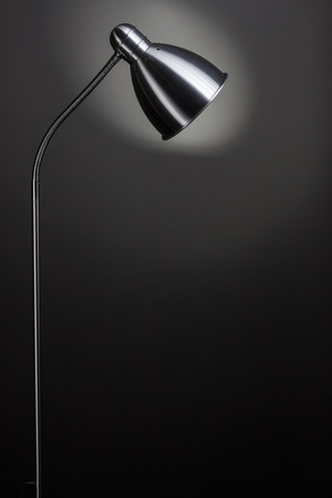 Modern floor lamp isolated on dark backgroundの写真素材