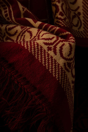 Red prayer rug isolated on black background