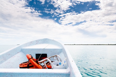 White boat sailing in open sea to the land at caribbean seaの写真素材