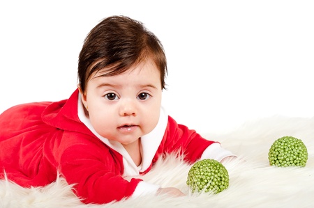 Baby dress as santa looking at camera on a blanket の写真素材