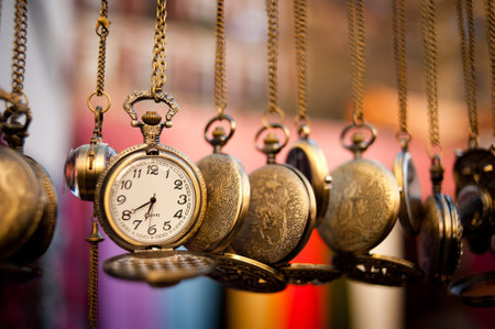 A set of pocketwatches hanging over a multicolor background