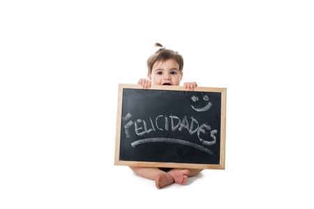 Baby holding a chalkboard with the word; felicidades handwriteの写真素材