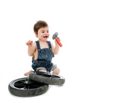 Pretty baby dressed as mechanic smile with a hammerの写真素材