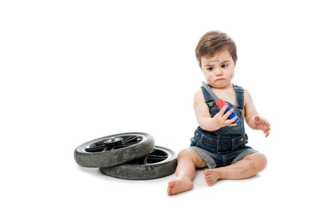 Pretty baby dressed as mechanic with a screwdriverの写真素材