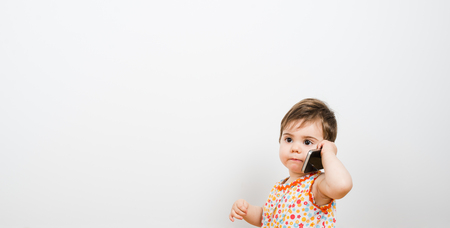 Pretty baby answering phoneの写真素材