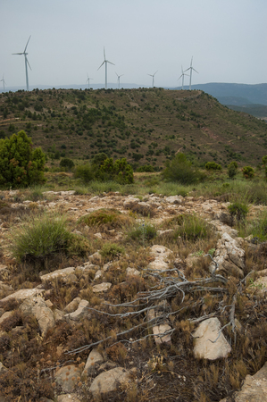 Landscape of a hill with some windmills on a stormy dayの写真素材