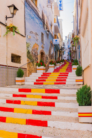 Calpe, Alicante, Spain. May 10, 2019: Old town. Puchalt street decorated with the colors of the Spanish flag. Painted facade Galeon hotelのeditorial素材