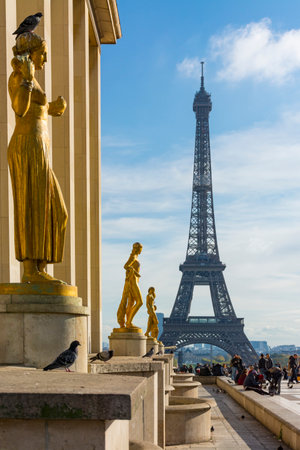 Paris, France - November 8, 2019: Golden sculptures on the busy esplanade of the Chaillot Palace, with the Eiffel Tower in the backgroundのeditorial素材