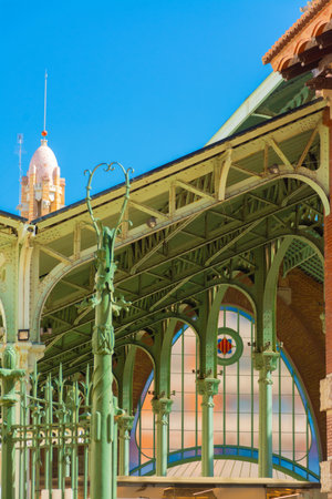 Valencia, Spain, March 14, 2021: Detail of the interior of the Mercado de Colon, or Columbus Market, arches, steel pillars and glass over one of the entrances. Old market, today a commercial buildingのeditorial素材