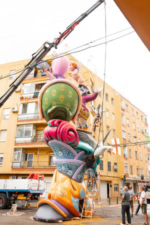 Catarroja, Valencia, Spain. September 1, 2021 - Artist workers assembling parts of a Valencian Falla with the help of a crane truck. Before the fall of the monumentのeditorial素材