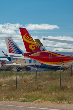 Caude, Teruel, Spain. 13th July, 2021 - Teruel Aerodrome the largest aircraft maintenance, long-term storage and recycling center in Europe. Tails of some planes next to a local roadのeditorial素材