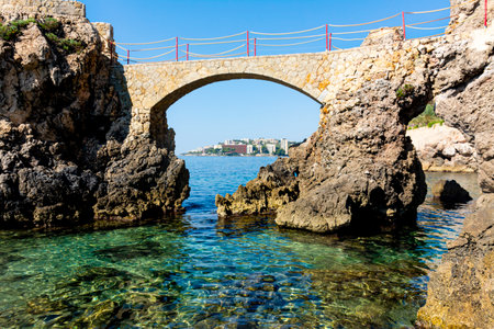 Es Pujolar on Cala Major beach, a small bridge to a small island near the coast. In the background the town of Cas Catala or Ses Illetesの写真素材