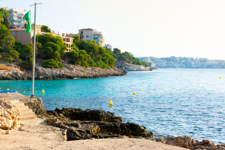 Illetes, Mallorca, Spain. July 20, 2022 - View of the inlet of the Comtesa cove from the rocky coast and the Cala Major cove, in Palmaのeditorial素材