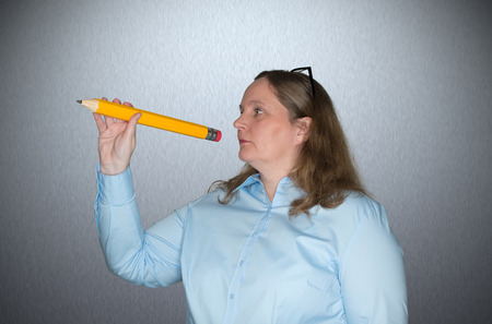 Woman with a pencil in handの写真素材