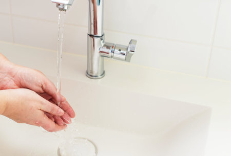 washing hand under running water