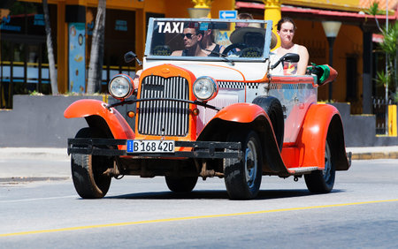 Orange American Cabriolet Classic Car dirves in Varadero City, Cubaのeditorial素材