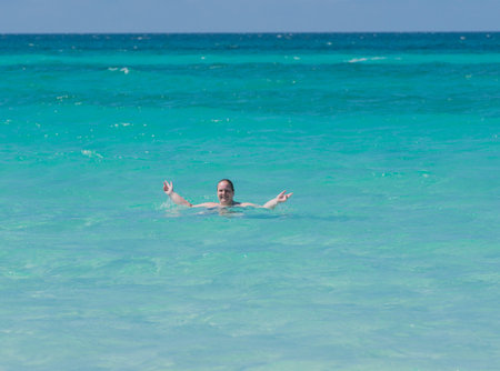 Woman in the sea in front of Varadero in Cubaの写真素材