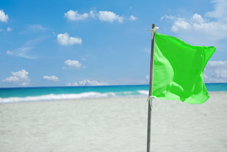 Green flag for warning at the beach on Cuba Varaderoの写真素材