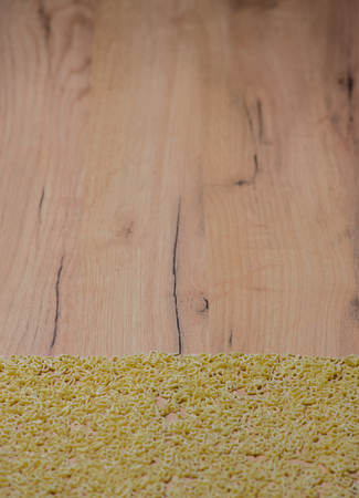Alphabet noodles on a wood backgroundの写真素材