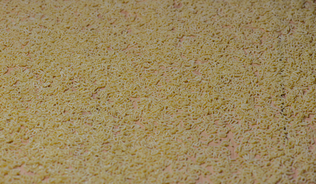 Alphabet noodles on a wood backgroundの写真素材