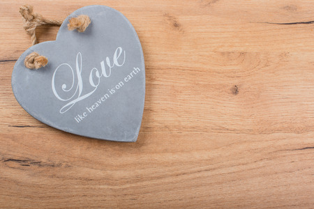 Wood background with slate heart as texture and backgroundの写真素材