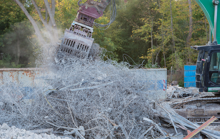 Demolition excavator rips off a buildingの写真素材