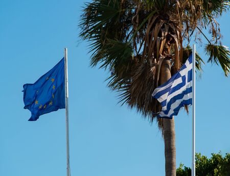 Greece flag in front of palm trees on Kos Islandの写真素材