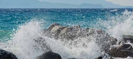 Waves at storm in Mediterranean Sea beating on breakwater on Kos Greece