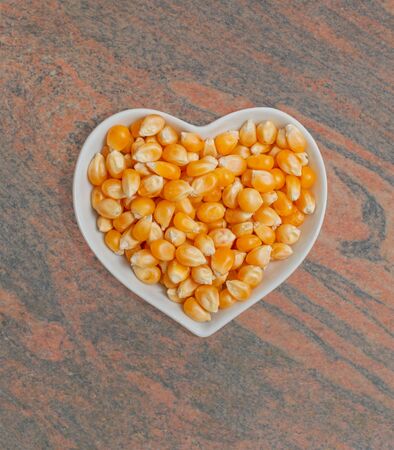 Corn kernels in a white bowl for food photographyの写真素材