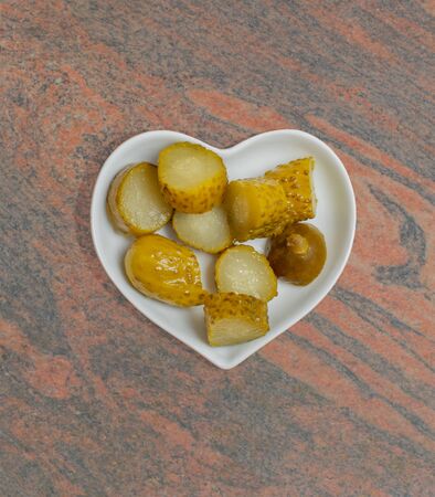 Pickled cucumbers in a white bowl for food photographyの写真素材