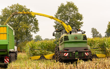 Agricultural machinery tractor and chopper during the corn harvestのeditorial素材