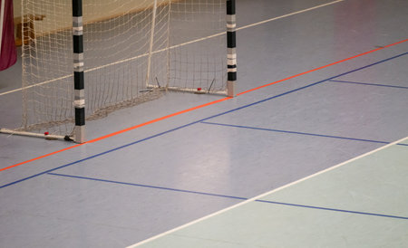 Handball goal and hall floor in a sports hall with various linesの写真素材