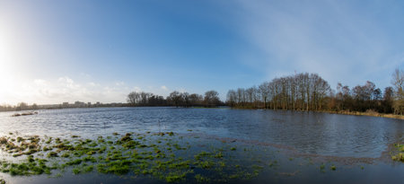 Fisheye perspective Fields and meadows flooded after a stormの写真素材