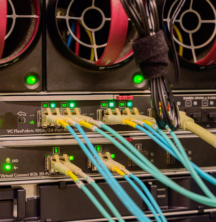 Fiber optic network cable connected to a switchの写真素材