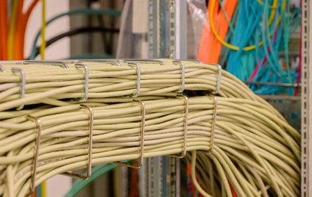 Cable arm in a server rack with RJ45 copper cable in a data centerの写真素材