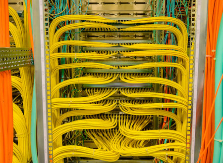 Yellow RJ45 copper cable - Network Cable in a network distribution rack in the data centerの写真素材