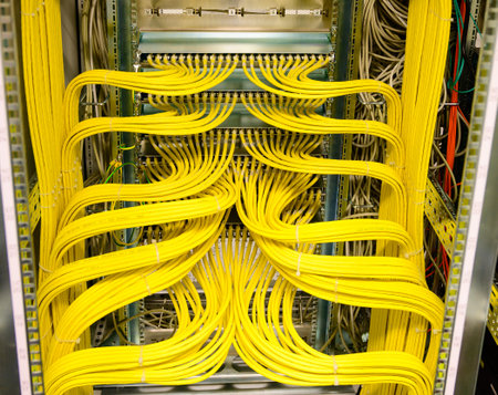 Yellow RJ45 copper cable - Network Cable in a network distribution rack in the data centerの写真素材