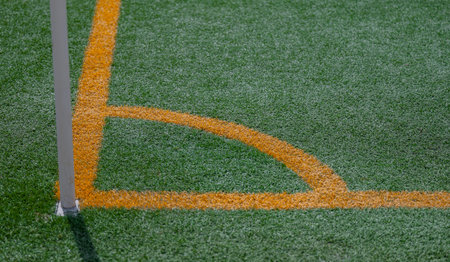 Close up on soccer field with artificial grass and orange stripesの写真素材
