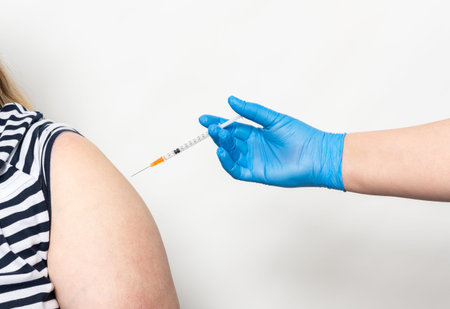 Woman vaccinated with a syringe and vaccine