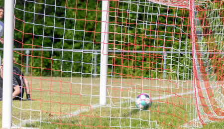 Soccer ball flies into the goalの写真素材