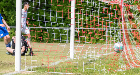 Soccer ball flies into the goalの写真素材