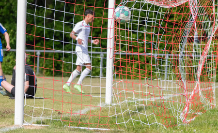 Soccer ball flies into the goalの写真素材